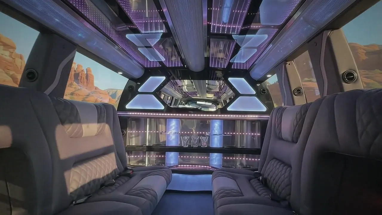 Inside the Cadillac Escalade limo in Pueblo: LED light-show ceiling, leather lounge seating and lit bar